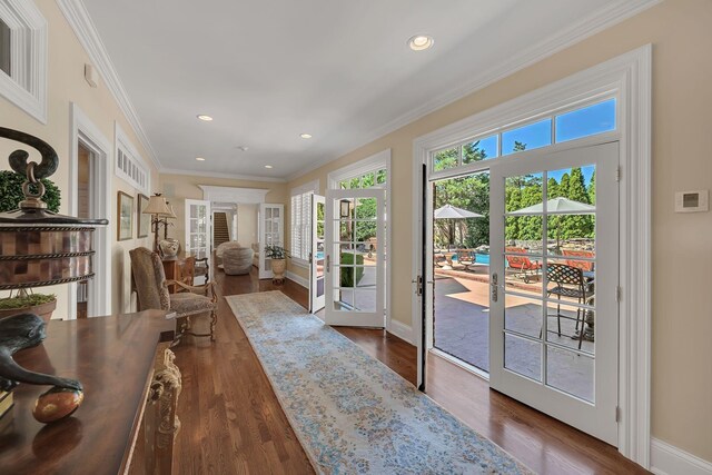 doorway with baseboards, recessed lighting, dark wood-style flooring, and crown molding