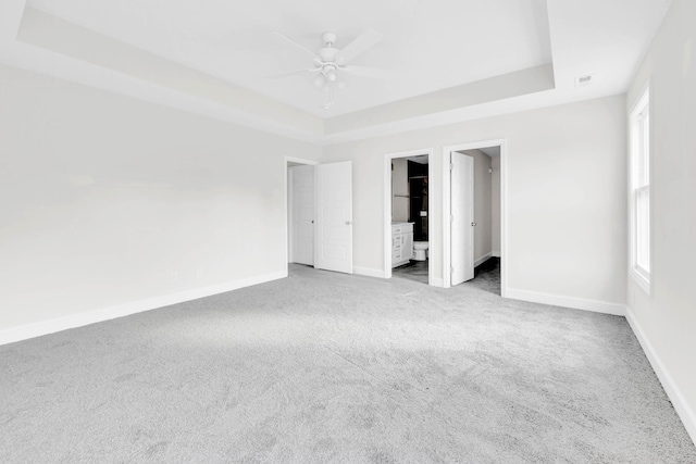 500 Herman Dr, Clarksville, TN 37042 - unfurnished bedroom with a tray ceiling, carpet, baseboards, and multiple windows