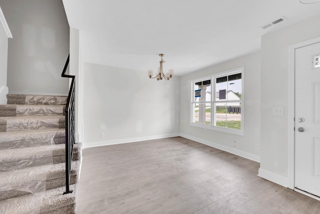 500 Herman Dr, Clarksville, TN 37042 - entryway featuring stairway, a chandelier, wood finished floors, and baseboards