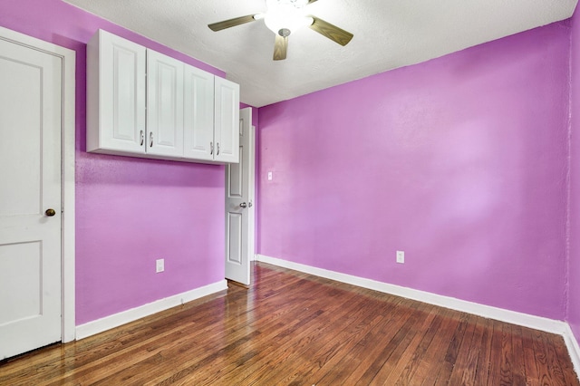 unfurnished room featuring a ceiling fan, a textured ceiling, wood finished floors, and baseboards