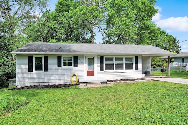 ranch-style house with fence, concrete driveway, a front yard, and entry steps
