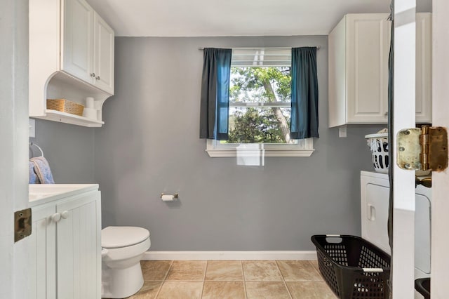 bathroom featuring baseboards, tile patterned floors, toilet, and vanity