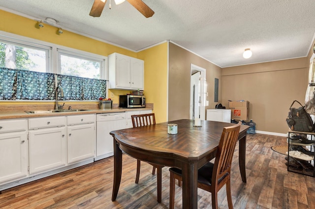 dining space with a textured ceiling, a ceiling fan, and wood finished floors