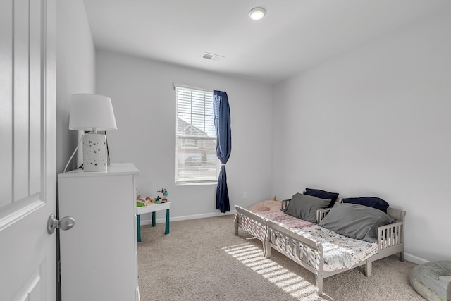 carpeted bedroom with baseboards and visible vents