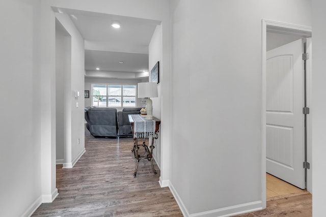 hall with recessed lighting, baseboards, and wood finished floors