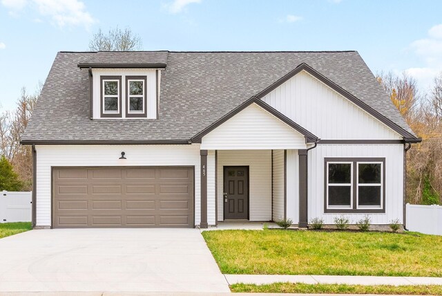 465 Herman Dr, Clarksville, TN 37042 - view of front of house featuring a front yard, driveway, a shingled roof, and fence