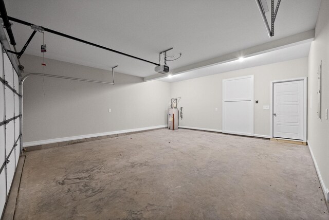 465 Herman Dr, Clarksville, TN 37042 - garage featuring water heater, a garage door opener, and baseboards