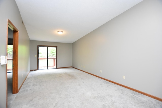 empty room with light carpet and baseboards