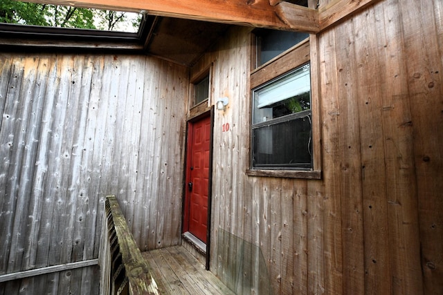 exterior space featuring wooden walls and hardwood / wood-style flooring