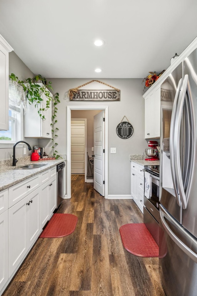 kitchen featuring white cabinets, a sink, stainless steel appliances, dark wood-style flooring, and recessed lighting