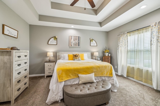 carpeted bedroom featuring recessed lighting, ceiling fan, a raised ceiling, and baseboards