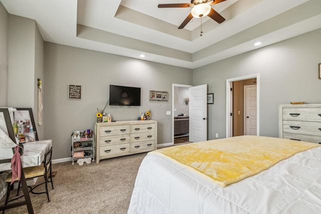 bedroom with baseboards, recessed lighting, carpet, and a tray ceiling