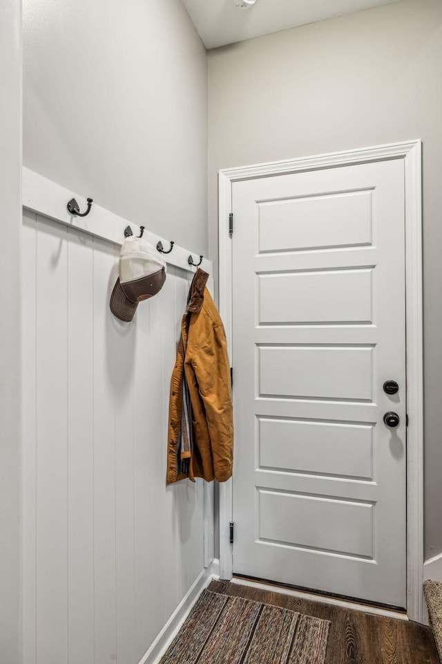 mudroom featuring baseboards and dark wood-type flooring