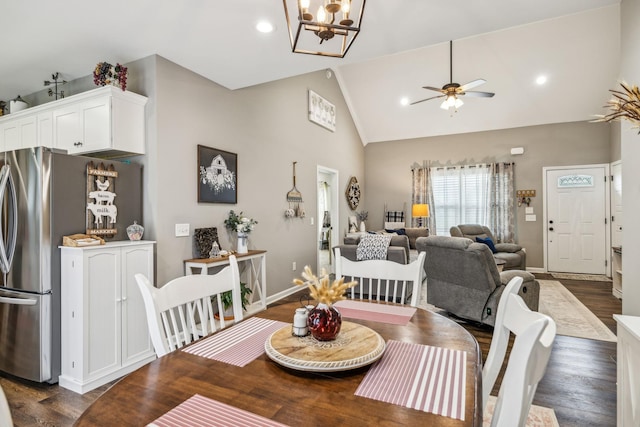 dining area with recessed lighting, high vaulted ceiling, dark wood-type flooring, baseboards, and ceiling fan with notable chandelier