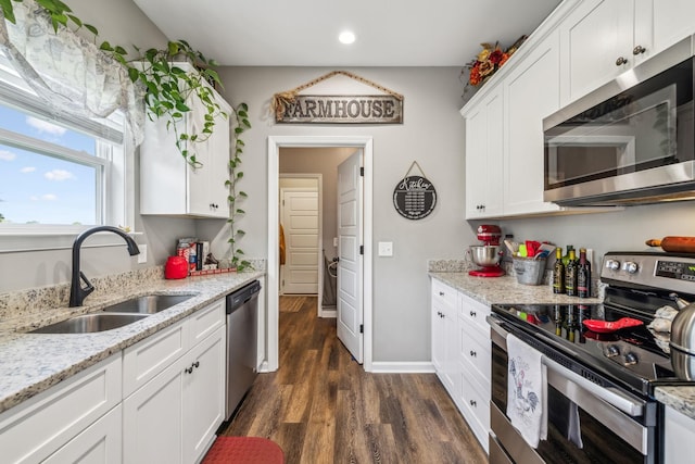 kitchen with recessed lighting, stainless steel appliances, a sink, white cabinetry, and dark wood-type flooring