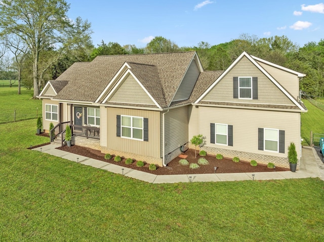 craftsman inspired home featuring board and batten siding, covered porch, crawl space, a front yard, and roof with shingles
