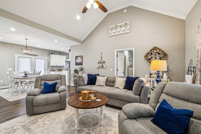 living room featuring baseboards, recessed lighting, vaulted ceiling, wood finished floors, and ceiling fan with notable chandelier