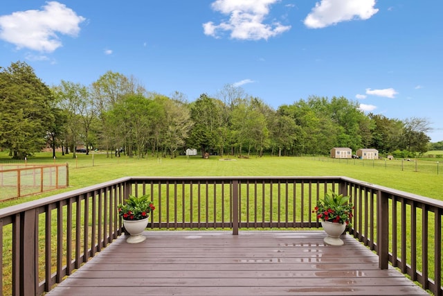 deck with a shed, an outbuilding, and a lawn