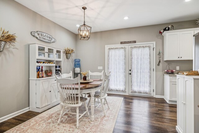 dining area featuring baseboards, recessed lighting, dark wood finished floors, french doors, and a notable chandelier