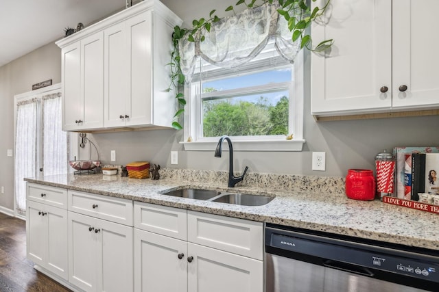 kitchen with a sink, dishwasher, and white cabinetry