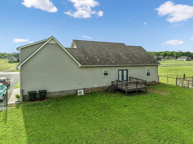 back of property with a yard, french doors, and fence