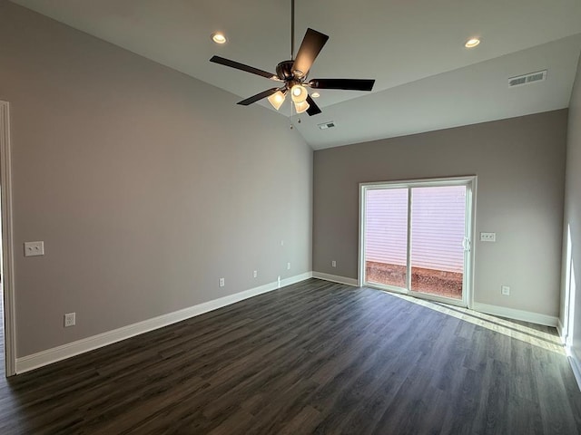 unfurnished room with dark wood-style floors, visible vents, lofted ceiling, and baseboards