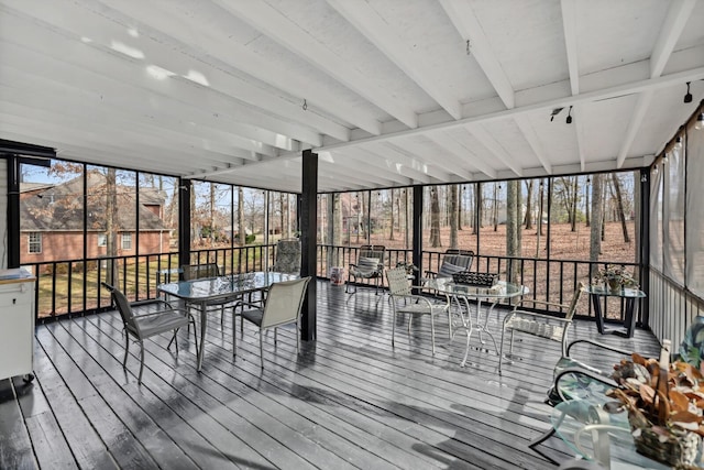 sunroom / solarium with outdoor dining area and a wealth of natural light