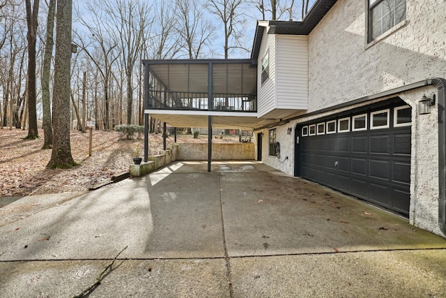 view of property exterior with stucco siding, concrete driveway, and a garage