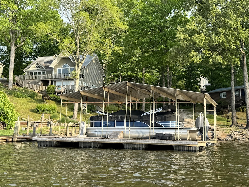 view of dock featuring boat lift and a water view