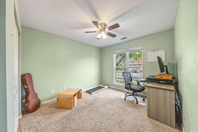 office area featuring baseboards, visible vents, ceiling fan, and carpet