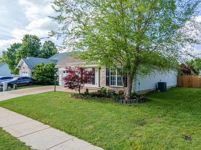 view of property hidden behind natural elements with a front lawn, a garage, driveway, central AC, and fence