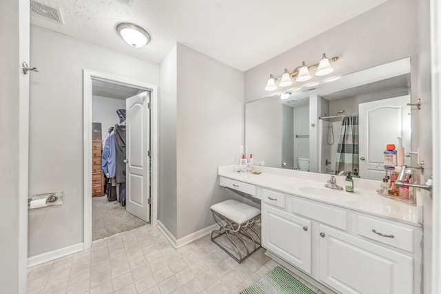bathroom with a shower with curtain, vanity, toilet, visible vents, and baseboards
