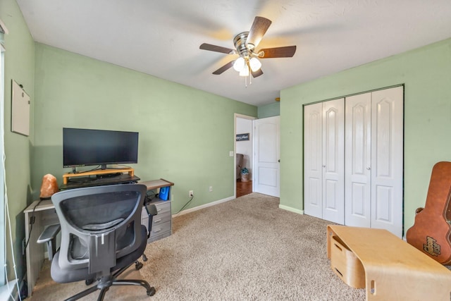 carpeted home office featuring ceiling fan and baseboards