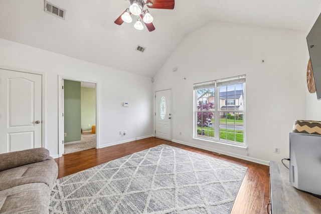 living area featuring visible vents, wood finished floors, a ceiling fan, and high vaulted ceiling
