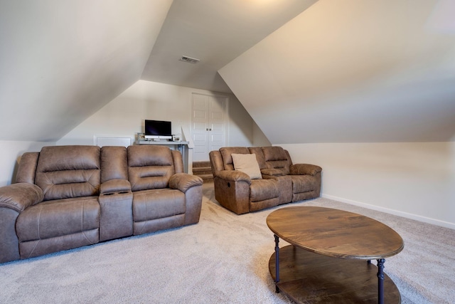 carpeted living area with visible vents, lofted ceiling, and baseboards