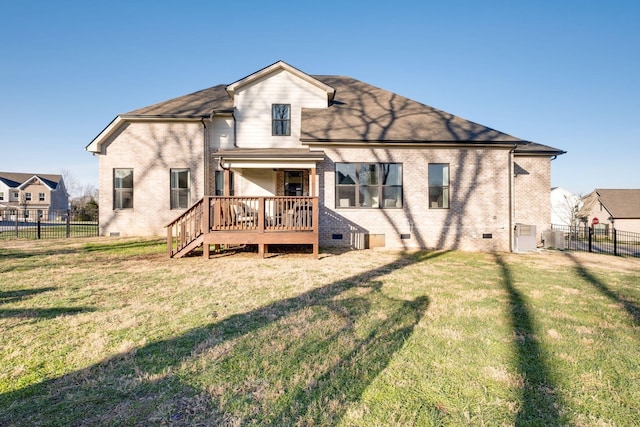 back of property featuring a yard, a deck, crawl space, and a fenced backyard