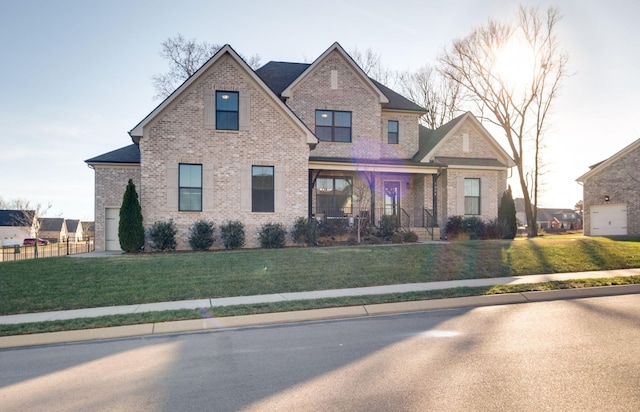 craftsman-style home featuring a garage, brick siding, a porch, and a front yard