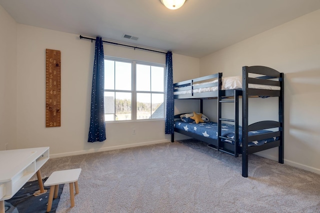 carpeted bedroom with baseboards and visible vents
