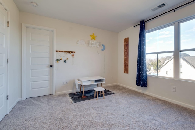 interior space featuring baseboards, visible vents, and carpet