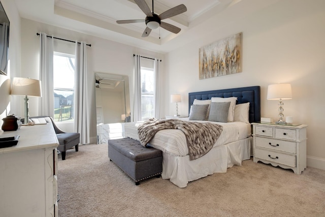 bedroom with light colored carpet, beamed ceiling, and multiple windows