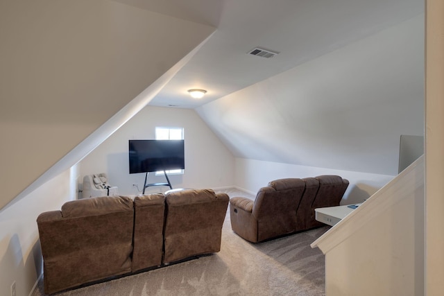 interior space featuring visible vents, light colored carpet, and lofted ceiling