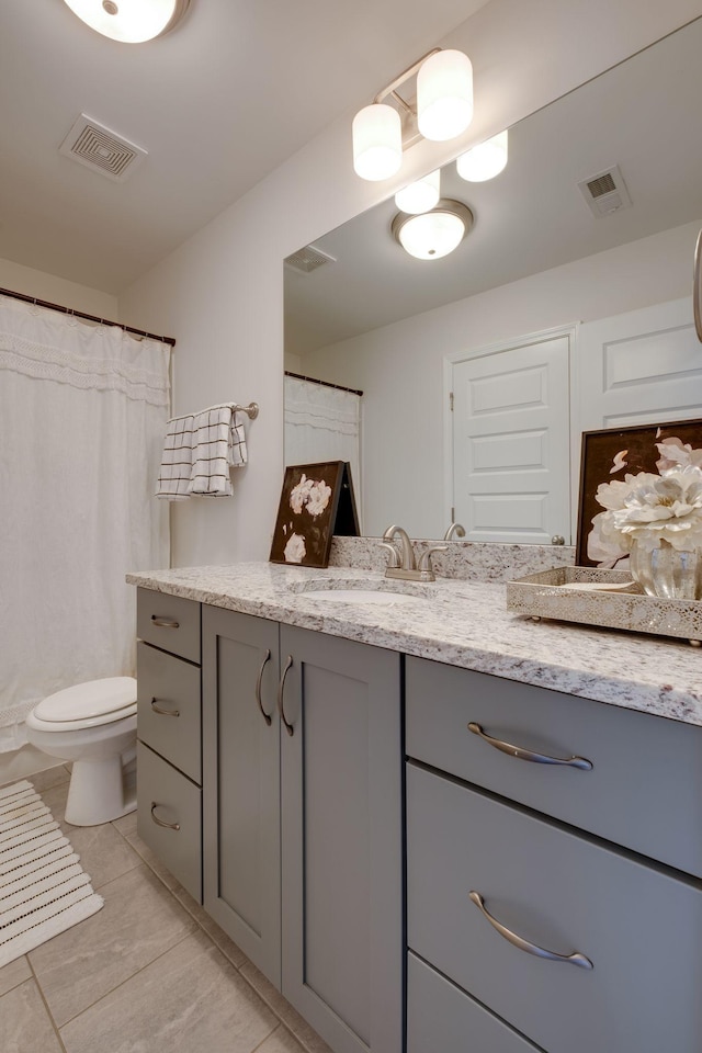 full bathroom with tile patterned floors, visible vents, toilet, and vanity