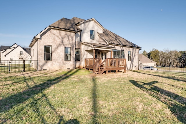 rear view of house with a wooden deck, crawl space, brick siding, and a fenced backyard