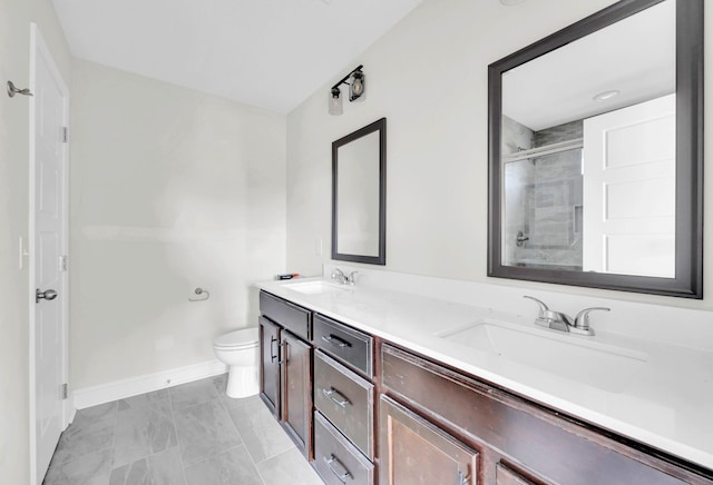 346 Galway Dr, Clarksville, TN 37042 - bathroom with a shower with shower door, double vanity, baseboards, and toilet