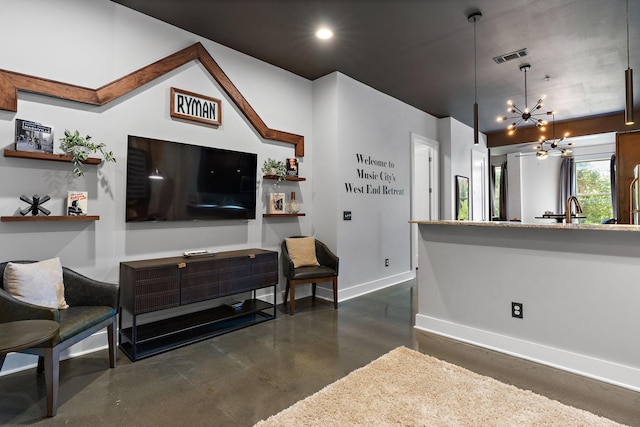living area with recessed lighting, concrete flooring, an inviting chandelier, visible vents, and baseboards