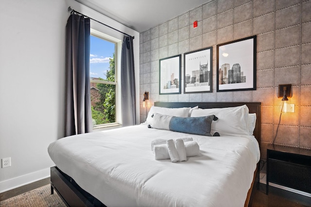 bedroom with tile walls and baseboards