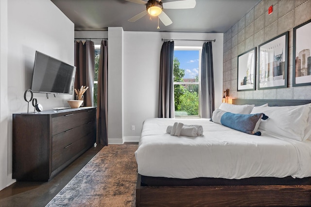 bedroom with ceiling fan and baseboards