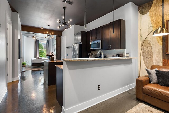kitchen featuring a notable chandelier, visible vents, baseboards, appliances with stainless steel finishes, and open floor plan