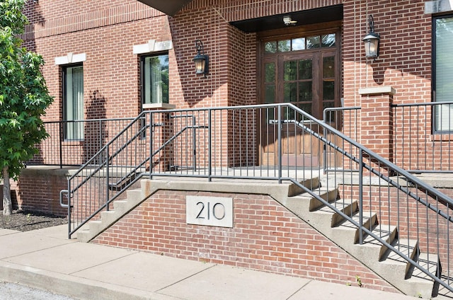 view of exterior entry with brick siding
