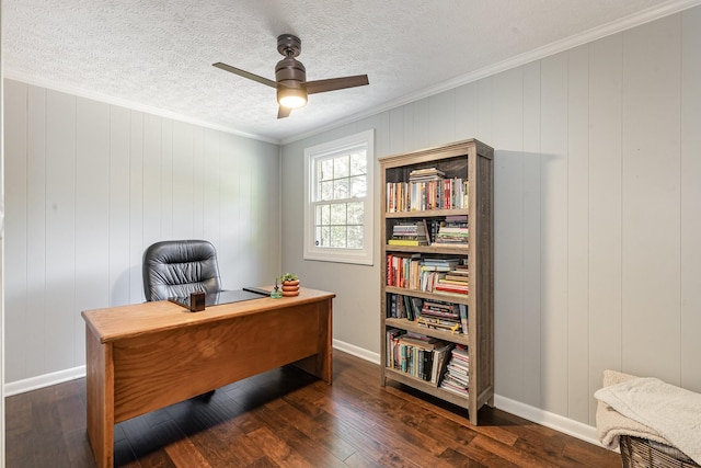 office featuring baseboards, hardwood / wood-style flooring, a ceiling fan, and crown molding